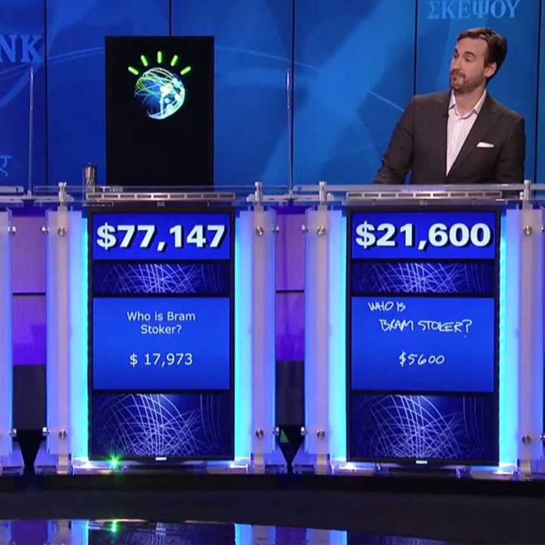 Contestants stand on the Jeopardy! stage as IBM Watson wins the quiz show, demonstrating advances in artificial intelligence (2011)